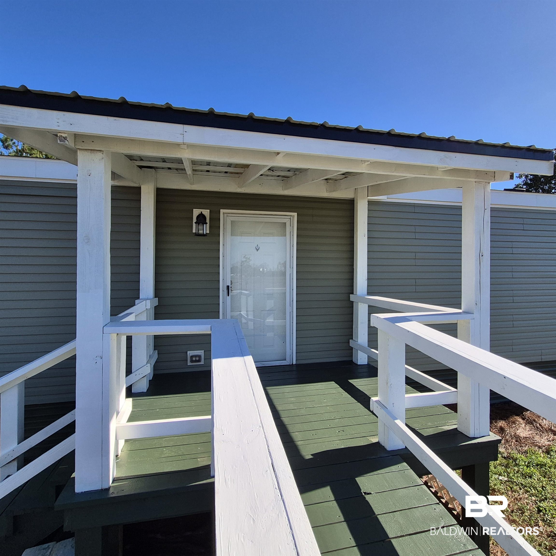8867 Old Stage Road Repton, AL 36475 - Photo 29 of 37 Property entrance with a wooden deck and a metal roof