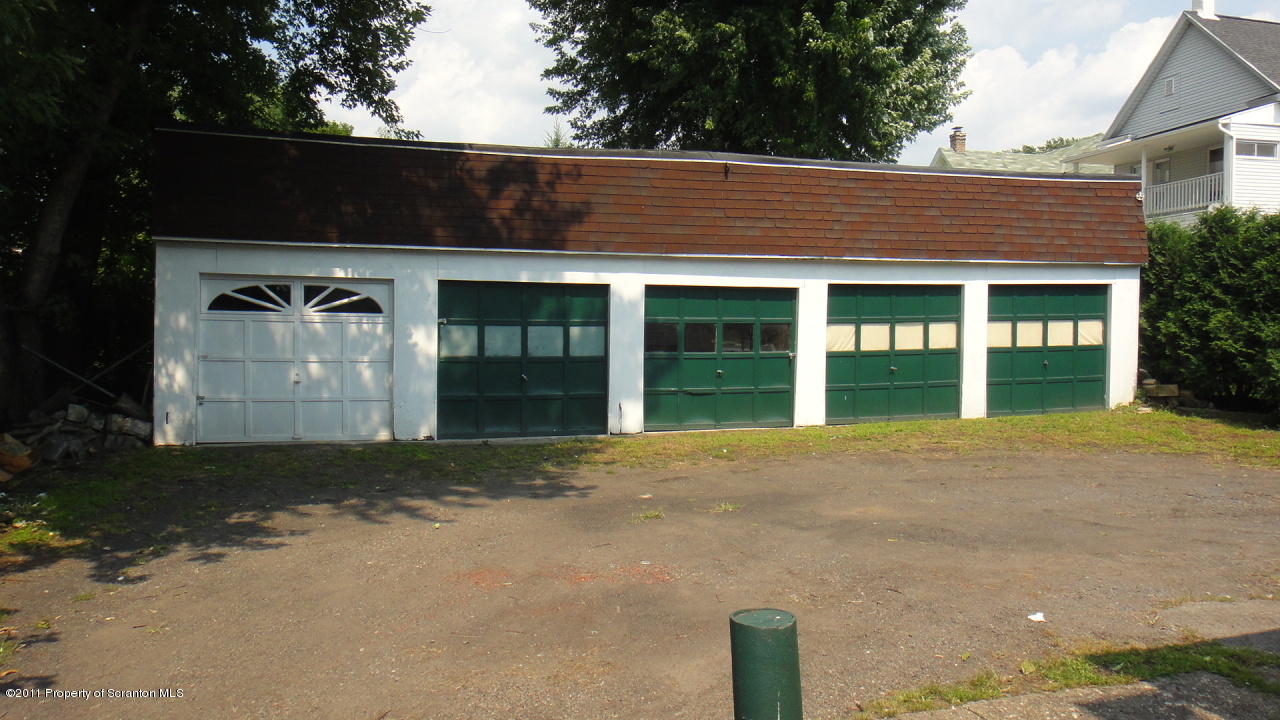 525 Green Ridge Street Scranton, PA 18509 - Photo 2 of 6 a front view of a house with a yard and garage