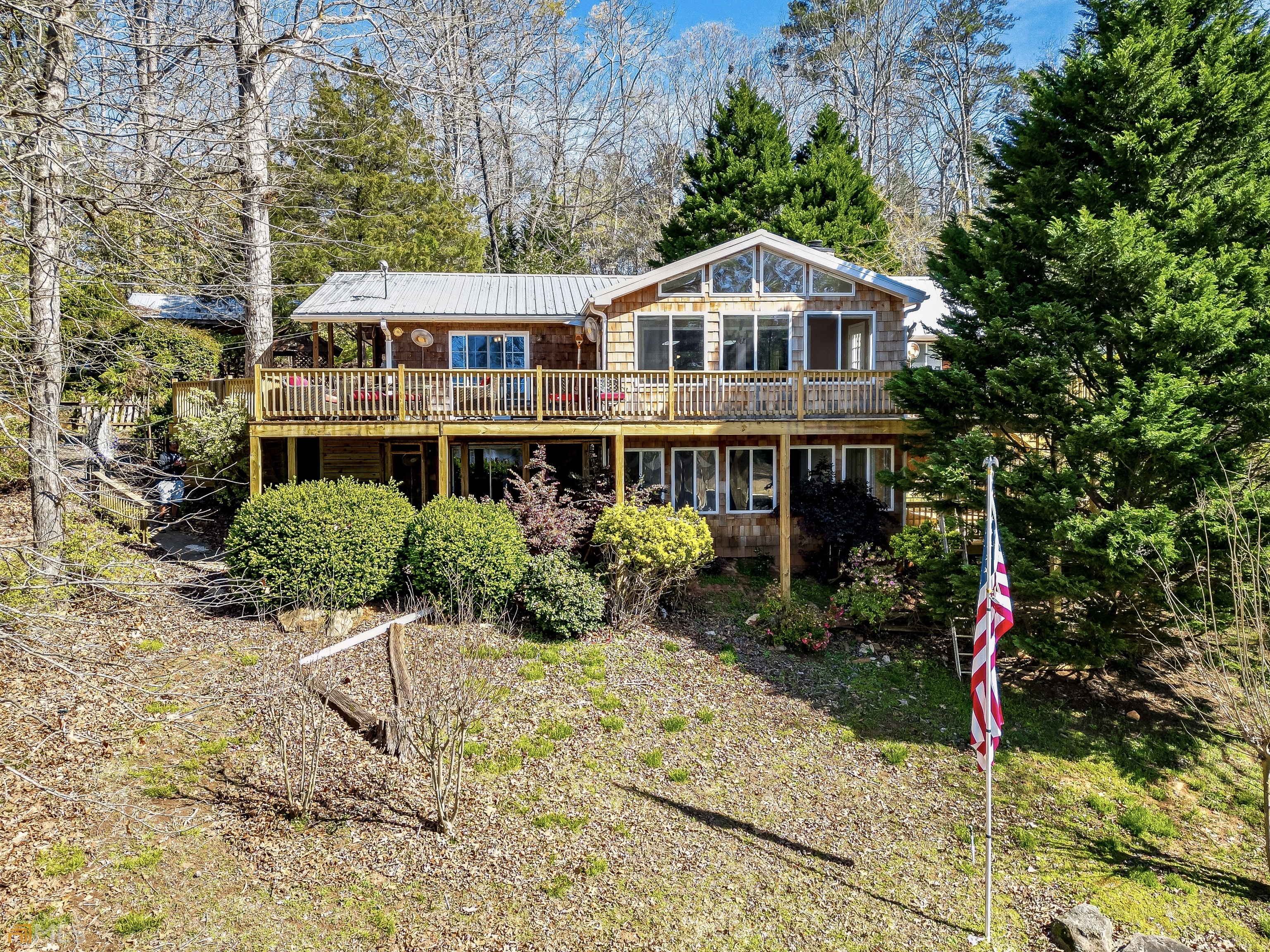 a front view of a house with yard and green space