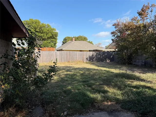 a view of a large garden with a small yard and large trees