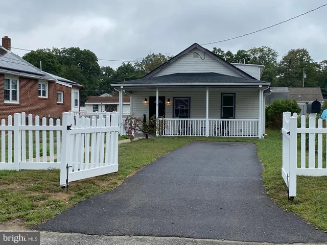 a front view of a house with wooden fence