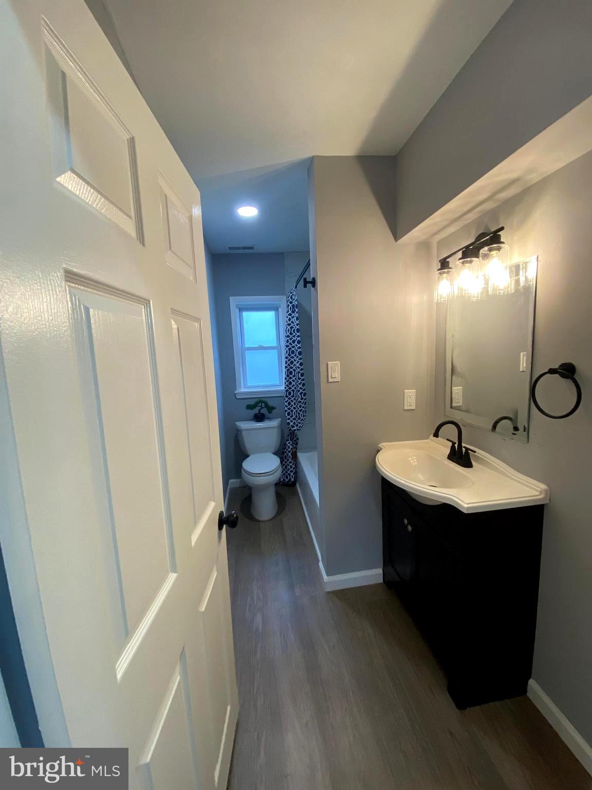 15 East 8th Avenue Pine Hill, NJ 08021 - Photo 15 of 32 a bathroom with a sink a toilet and a mirror