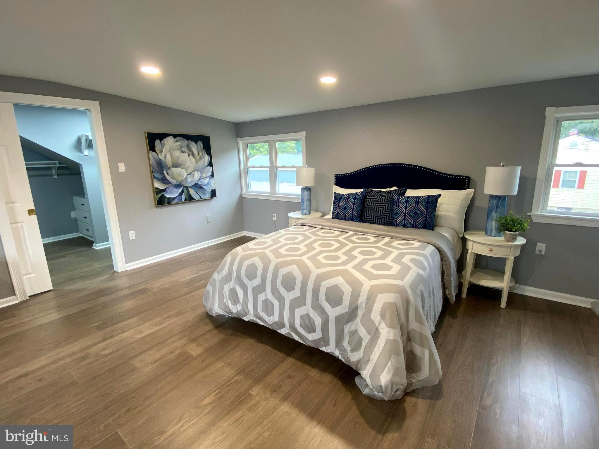 15 East 8th Avenue Pine Hill, NJ 08021 - Photo 25 of 32 a bedroom with a bed and a painting on the wall