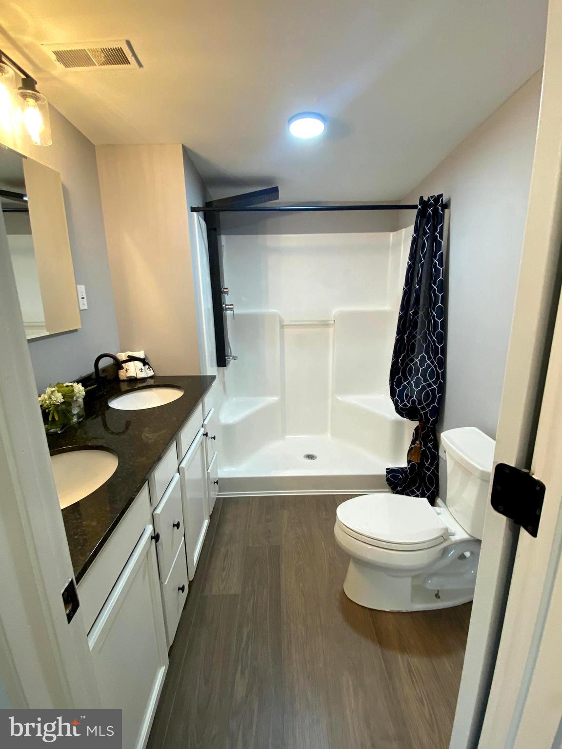 15 East 8th Avenue Pine Hill, NJ 08021 - Photo 31 of 32 a bathroom with a double vanity sink toilet and mirror