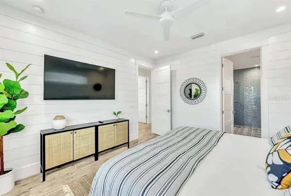 a spacious bedroom with a bed and a window