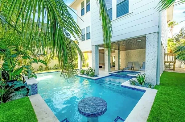a backyard of a house with table and chairs