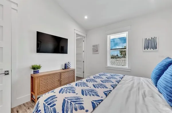 a bedroom with a bed and wooden floor