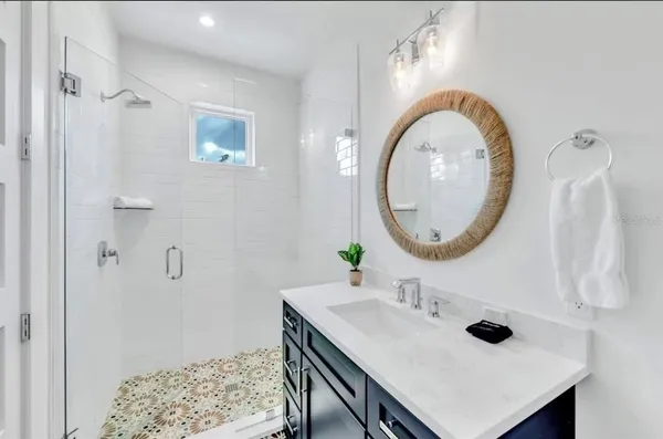 a bathroom with a toilet sink vanity and mirror