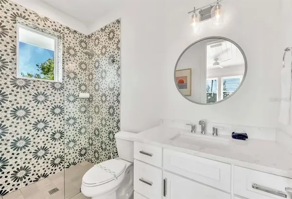 a bathroom with a double vanity sink mirror and shower