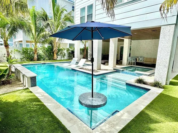 a patio with a table and chairs under an umbrella