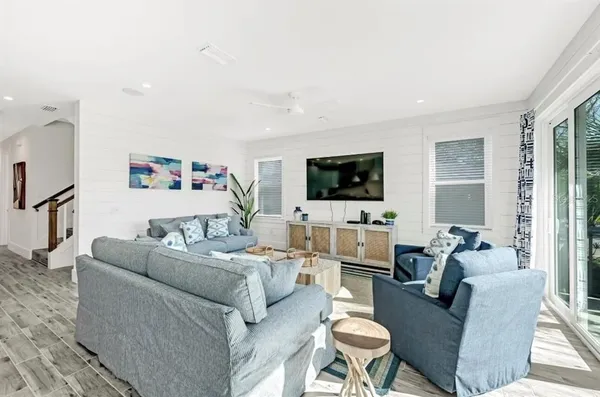 a living room with furniture wooden floor and a flat screen tv