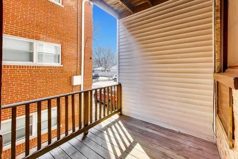 a view of a balcony with wooden floor