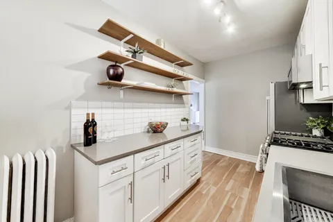 a kitchen with stainless steel appliances a sink and cabinets