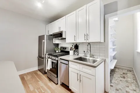 a kitchen with a sink stove and refrigerator