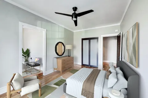 a bedroom with a bed a chandelier and a window