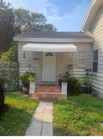 a view of house with a yard