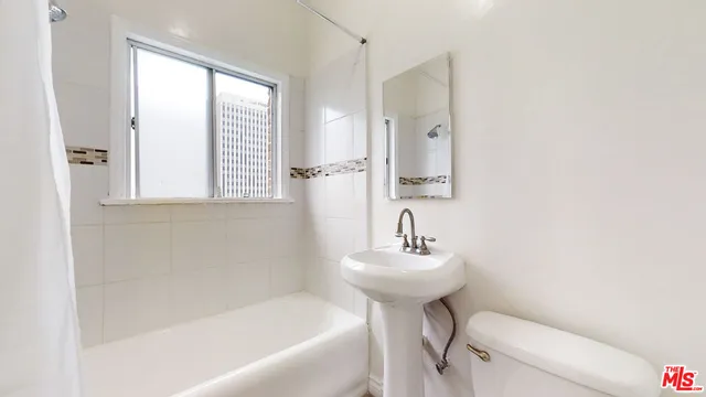 a bathroom with a sink toilet and a bathtub