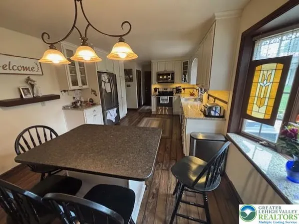 a view of a dining room with furniture and chandelier