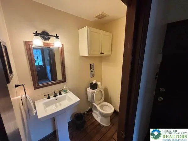 a bathroom with a sink toilet and mirror