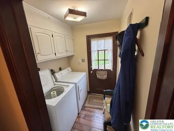 a view of a door and washer and dryer
