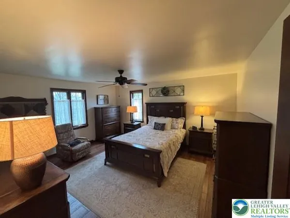 a bedroom with a bed couch and dresser