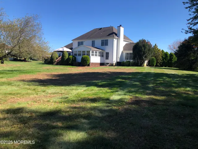 a dining room with furniture a chandelier and a flat screen tv