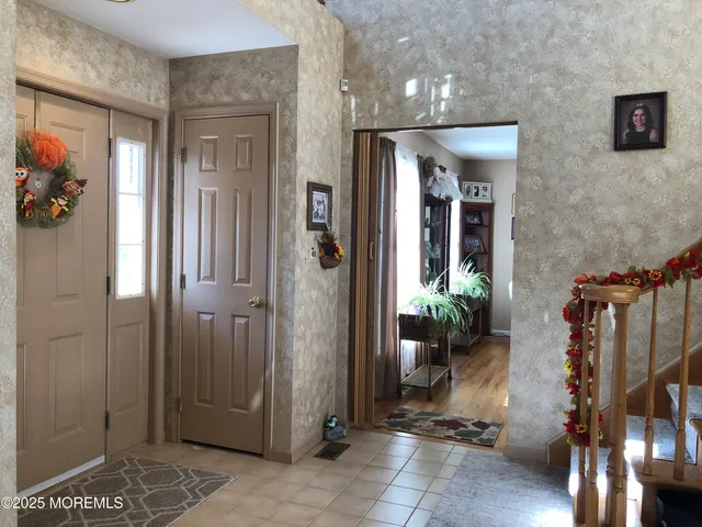 a dining room with furniture a chandelier and potted plants