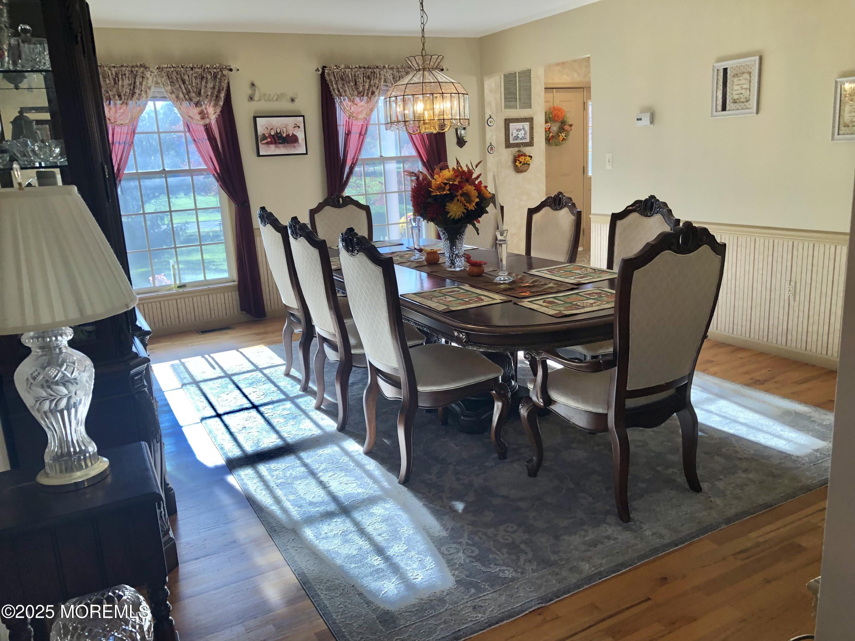 10 Saddlebrook Road Millstone Township, NJ 08535 - Photo 28 of 86 a view of a dining room with furniture a chandelier and wooden floor