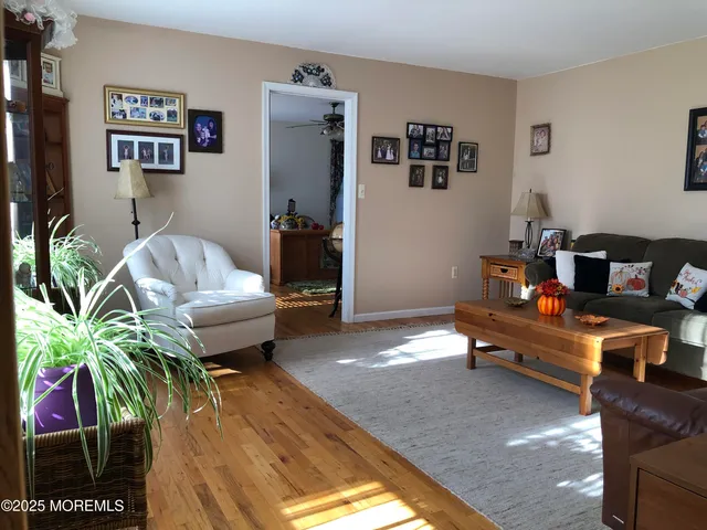 a living room with furniture a flat screen tv and a large window