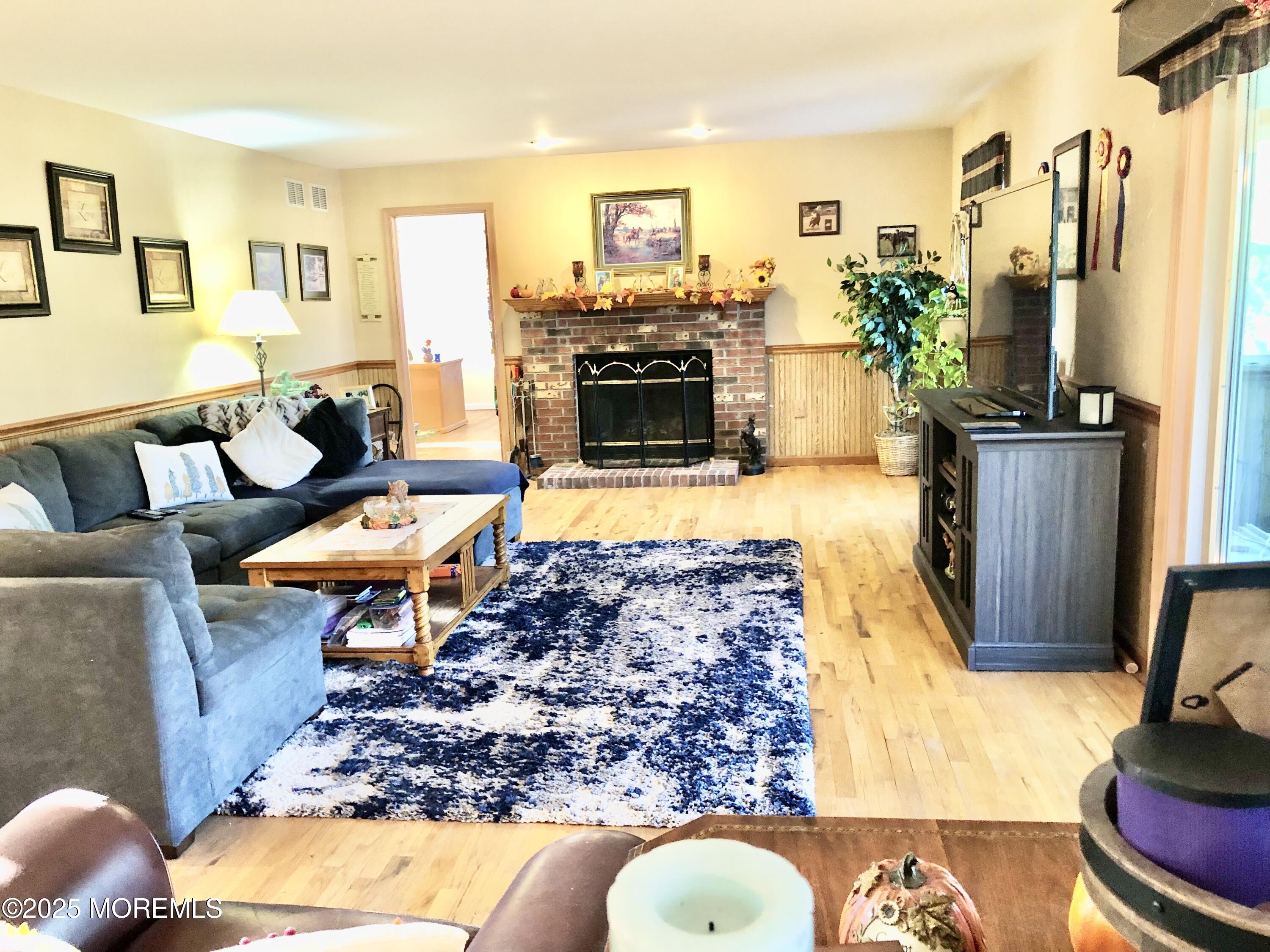 10 Saddlebrook Road Millstone Township, NJ 08535 - Photo 43 of 86 a living room with furniture a flat screen tv and a fireplace