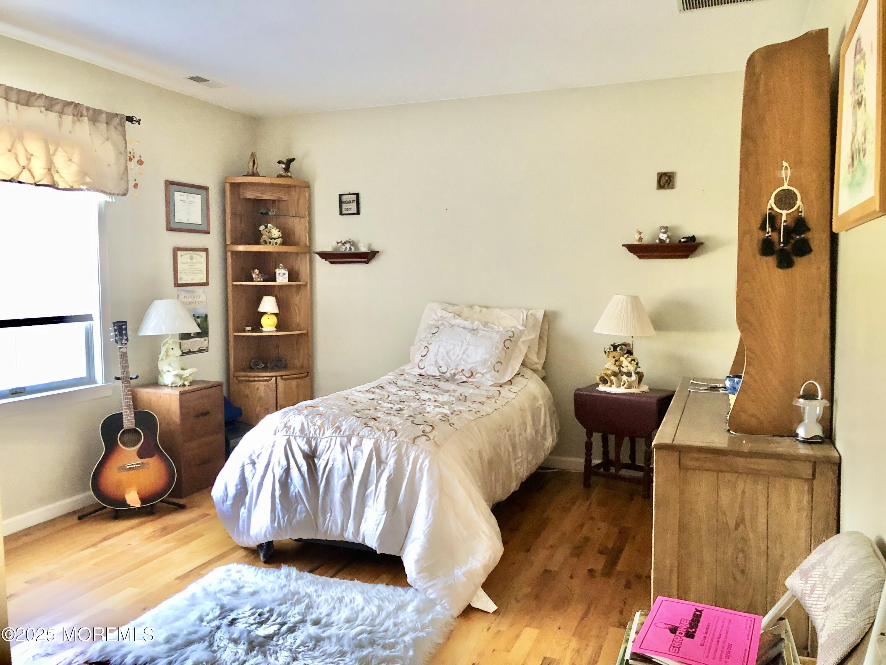 10 Saddlebrook Road Millstone Township, NJ 08535 - Photo 79 of 86 a bedroom with a bed and wooden floor