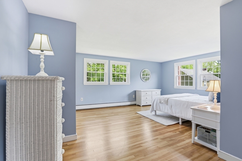94 Johnson Road Winchester, MA 01890 - Photo 20 of 40 a spacious bedroom with a bed and a lamp on table