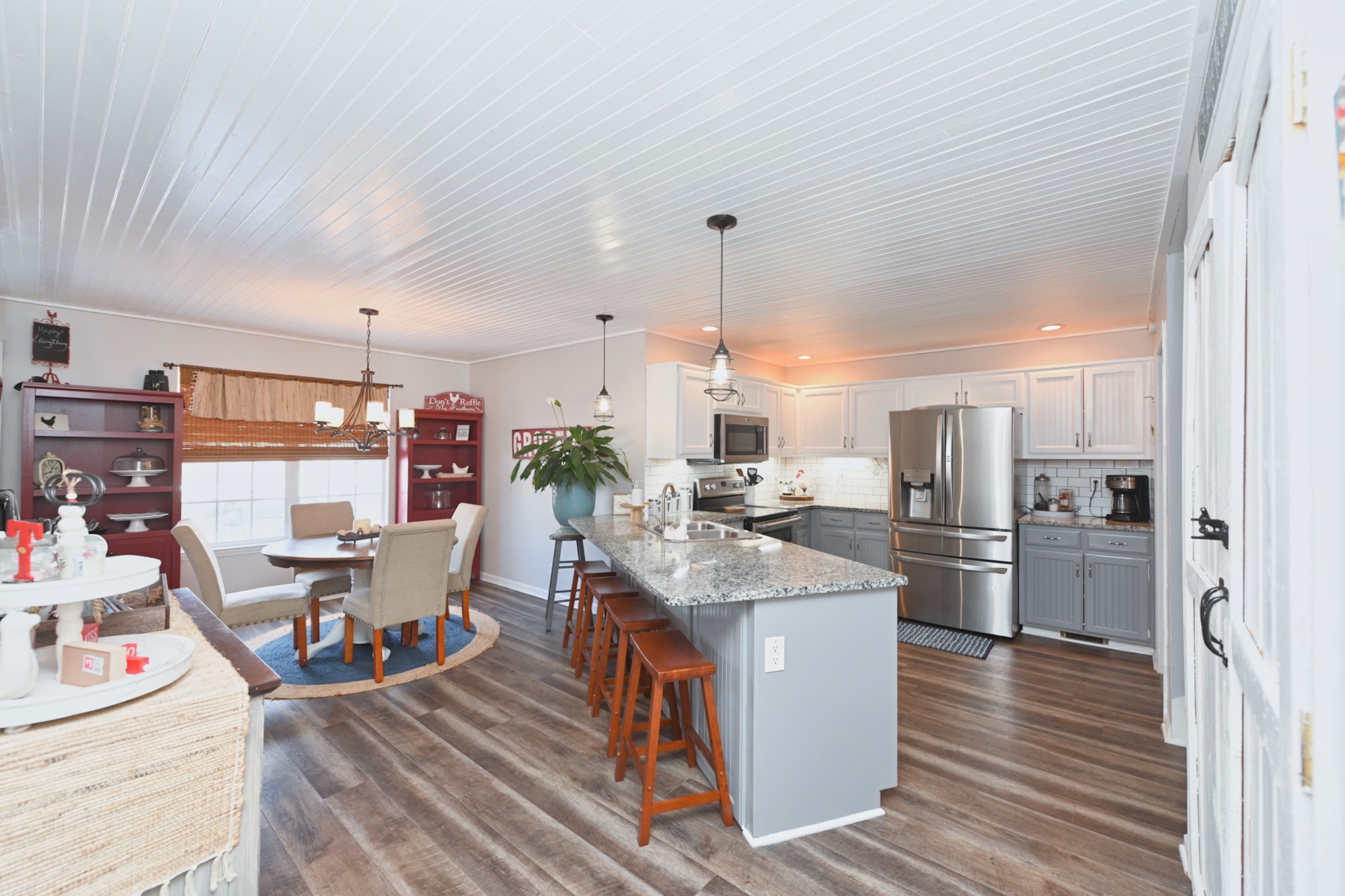 3376 Maxie Jones Road Springfield, TN 37172 - Photo 13 of 48 a kitchen with stainless steel appliances kitchen island granite countertop a table chairs stove and cabinets