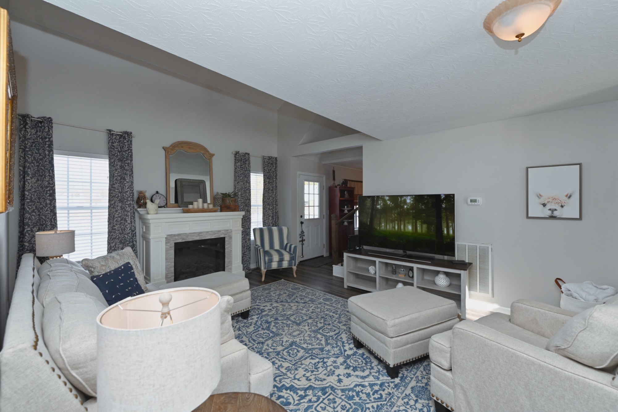 3376 Maxie Jones Road Springfield, TN 37172 - Photo 10 of 48 a living room with furniture a flat screen tv and a fireplace