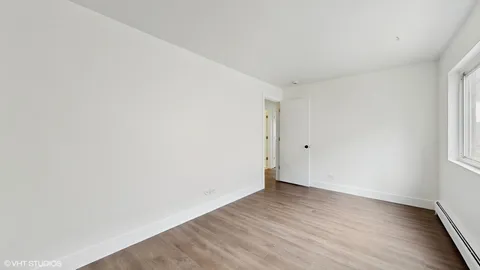an empty room with wooden floor