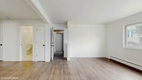 a view of a room with wooden floor and window