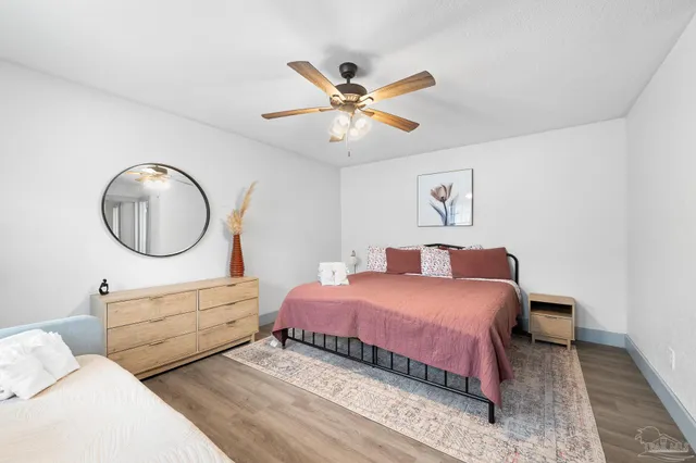a bedroom with a large bed and a chandelier