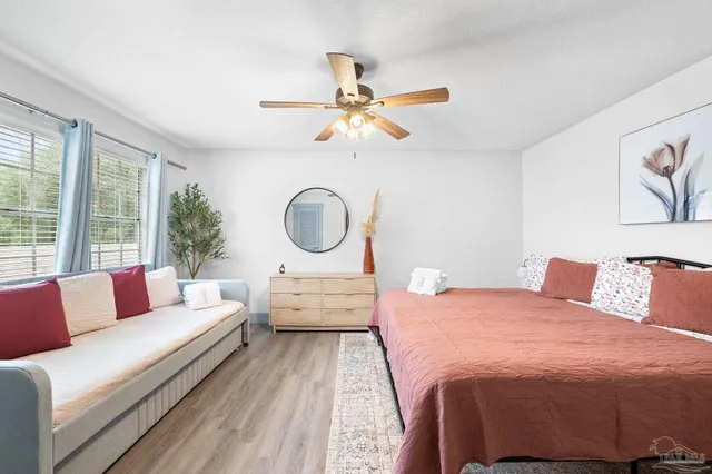 a bathroom with a granite countertop sink mirror vanity and toilet