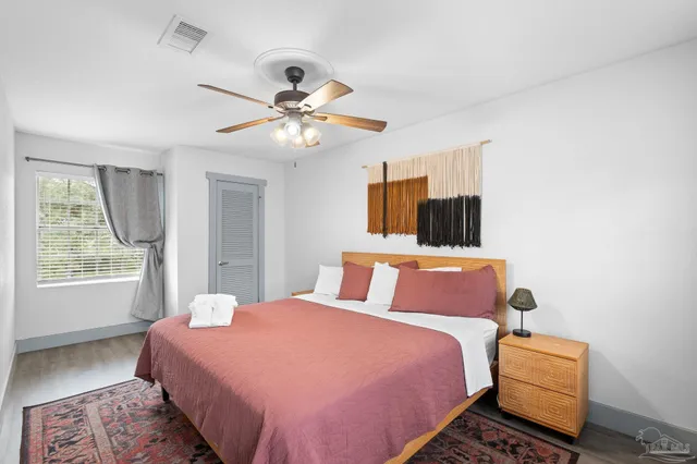 a spacious bedroom with a bed and a chandelier