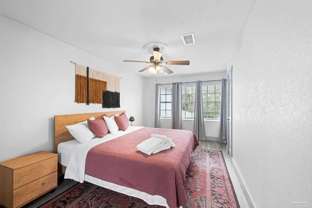 a bathroom with a granite countertop toilet sink and mirror