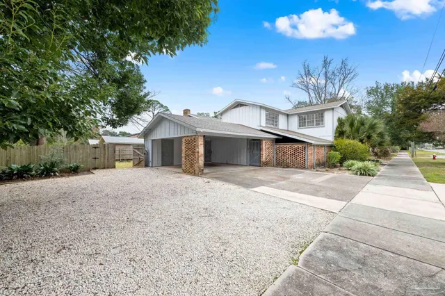 a front view of a house with a yard and a garage