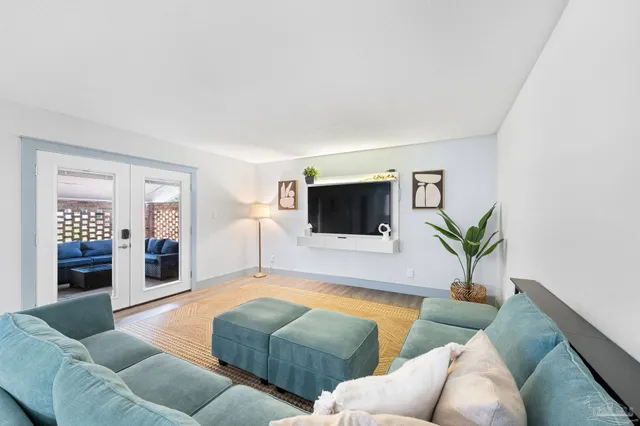 a view of a dining room with furniture and wooden floor
