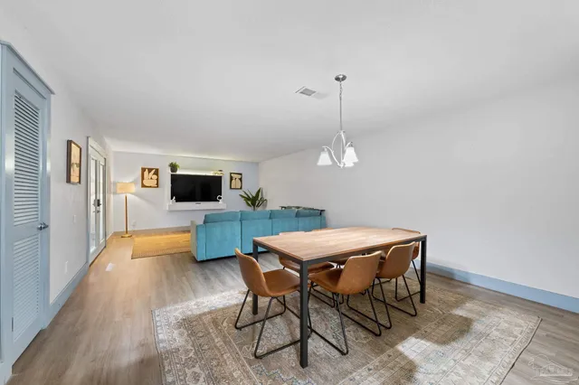 a dining room with a table and chairs