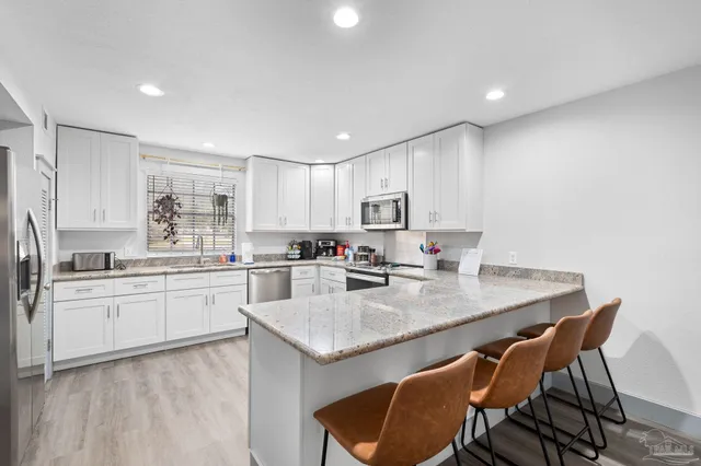 a bathroom with a sink toilet and mirror