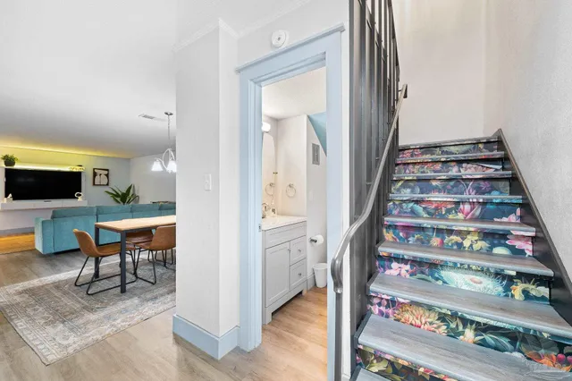 a bedroom with a bed a mirror and paintings on the wall