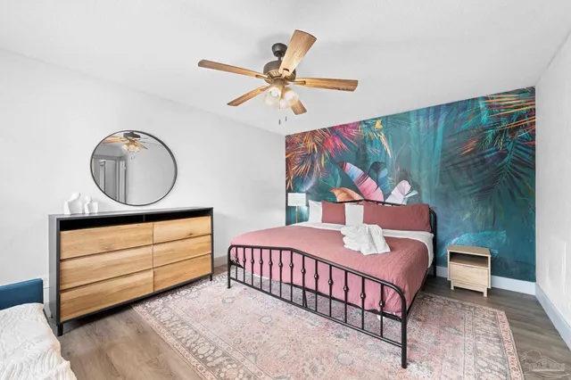 a bedroom with a bed and a large window