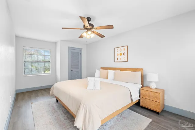 a bedroom with a bed and a chandelier