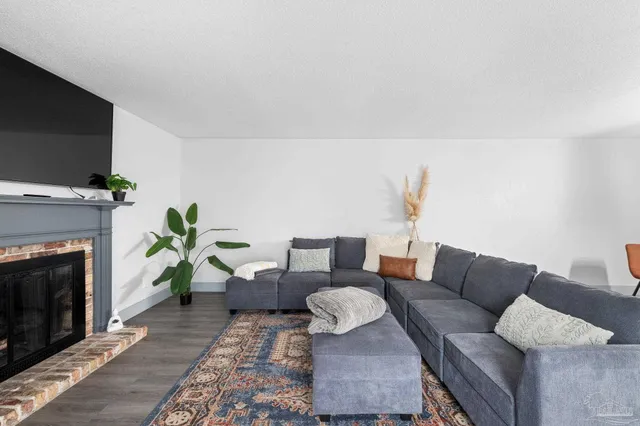 a view of a dining room with furniture a chandelier and wooden floor
