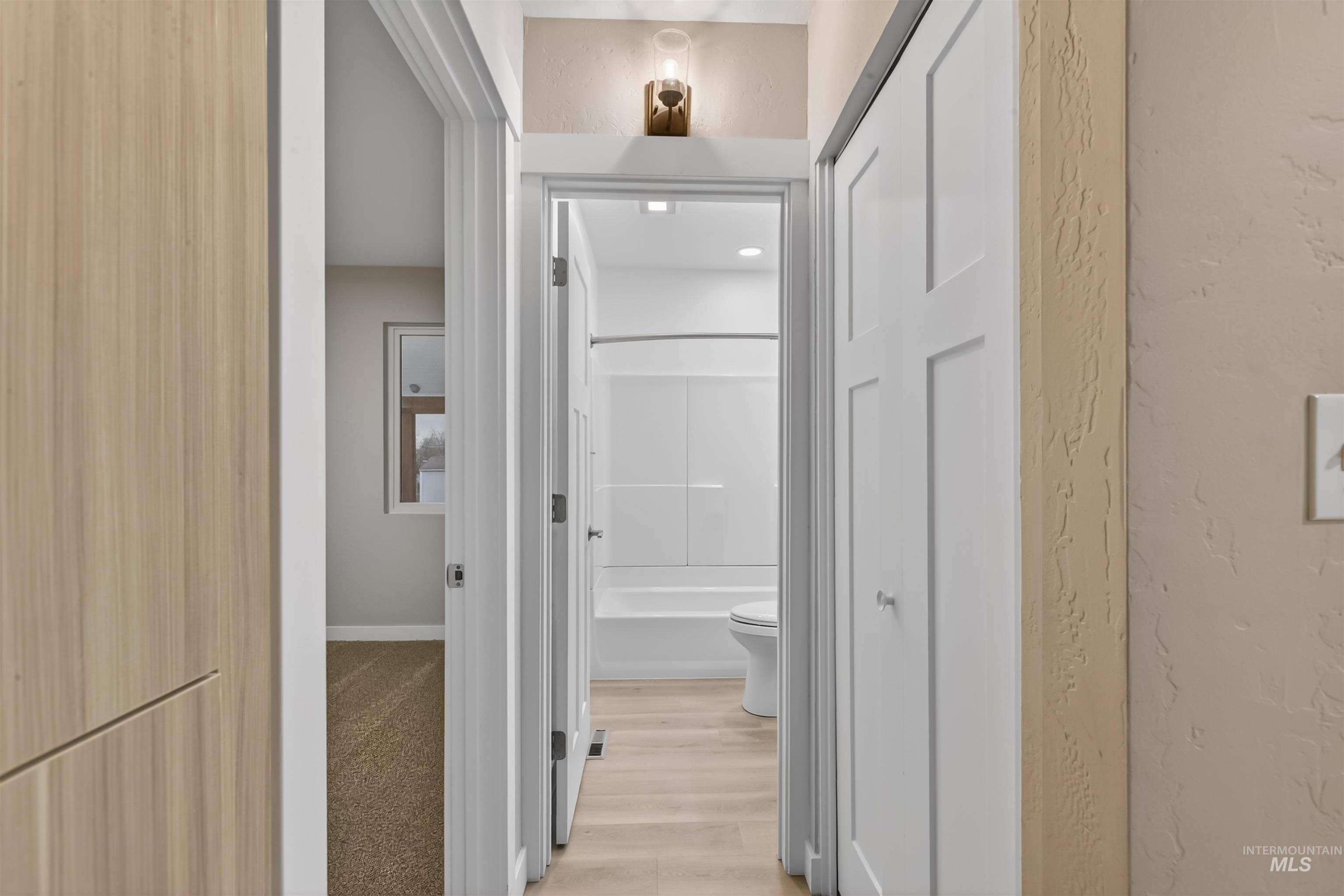 929 10th Street Clarkston, WA 99403 - Photo 15 of 43 Hall with a textured wall and light wood-style floors