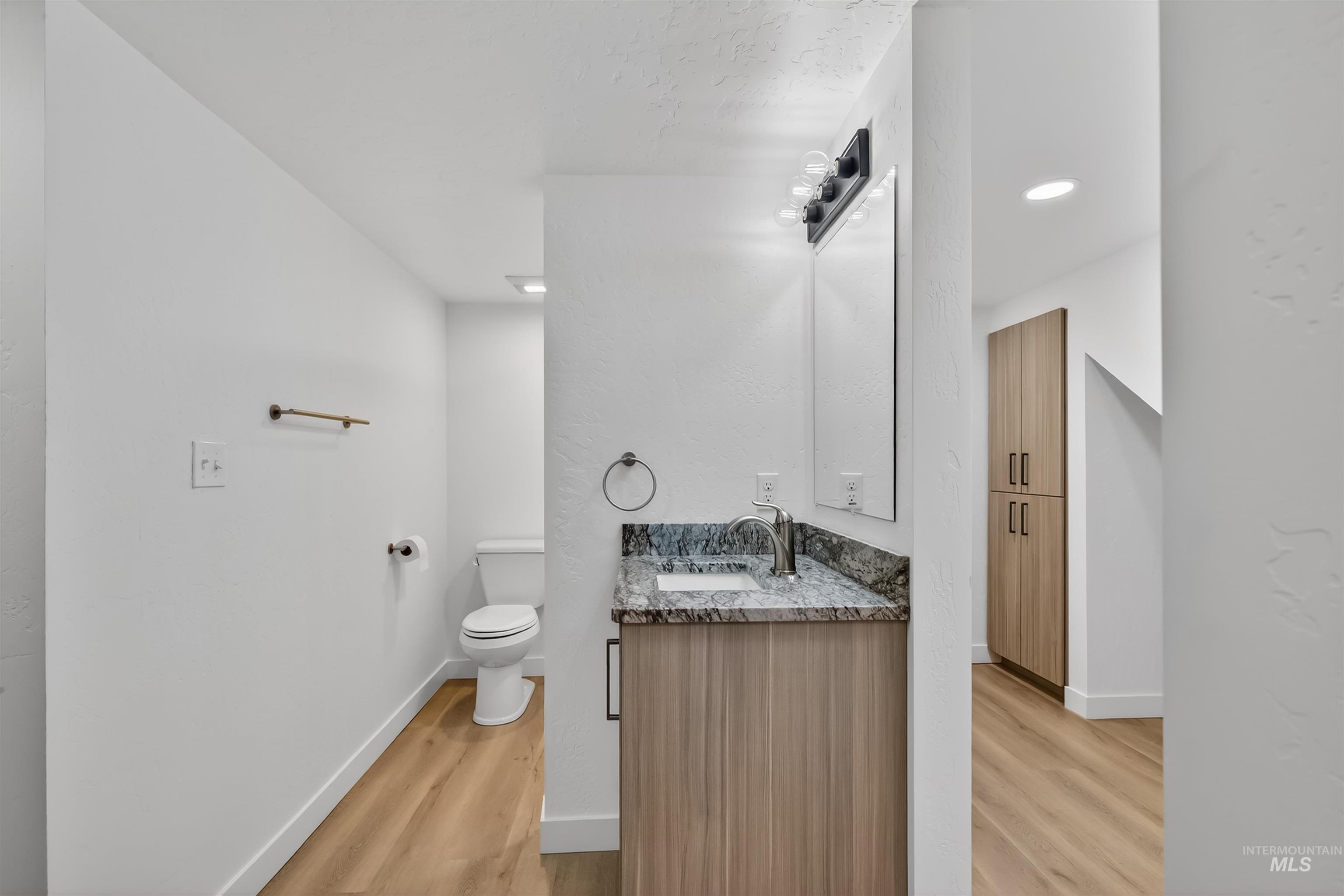 929 10th Street Clarkston, WA 99403 - Photo 28 of 43 Half bath with vanity, light wood finished floors, and recessed lighting